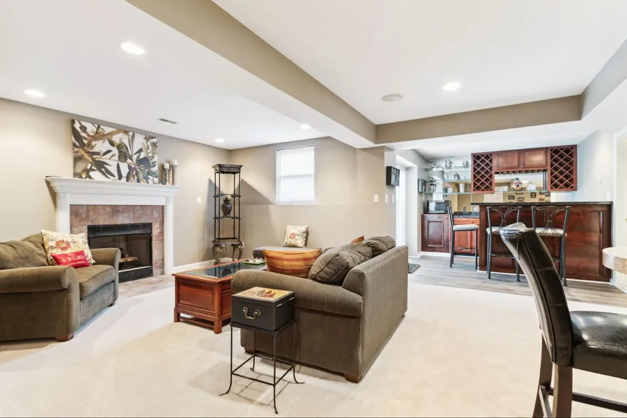 Sold home — lower-level family room with fireplace and built-in wet bar