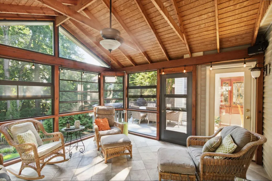 Sold home — screened porch with cedar ceiling and wicker seating