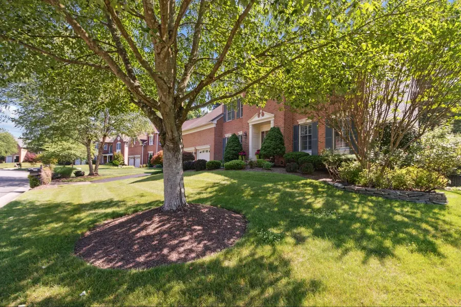 Sold home — brick front exterior framed by a mature shade tree